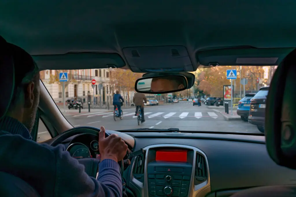 A driver approaching a pedestrian crossing, following California Pedestrian law.