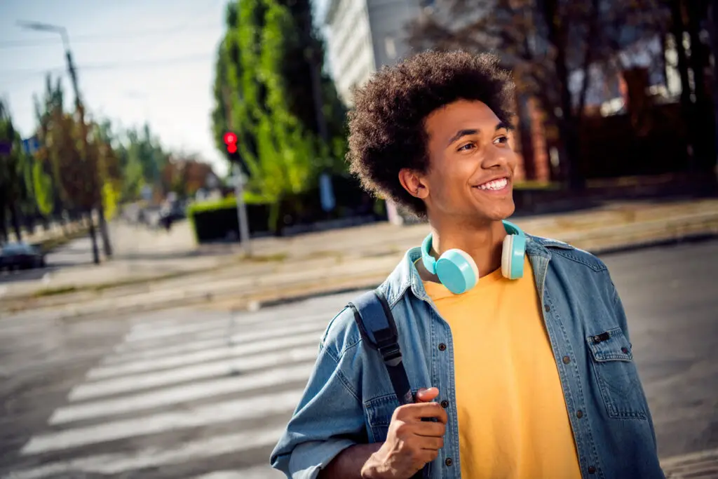 A pedestrian crossing the street happily.