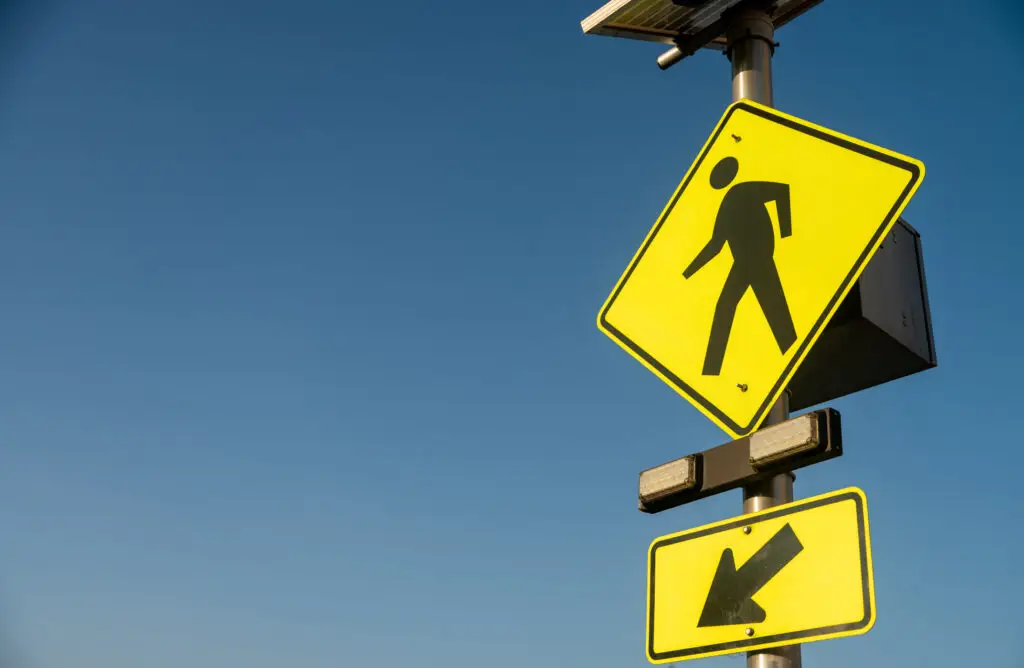 This pedestrian crossing sign indicating pedestrians cross here.