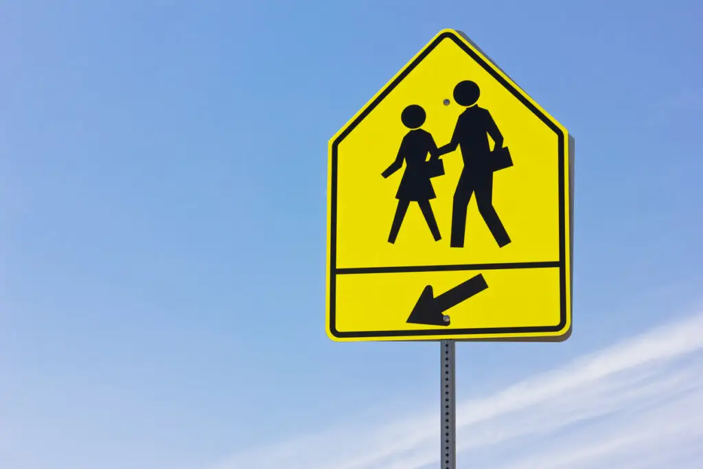 This pedestrian crossing sign indicates a school is nearby.