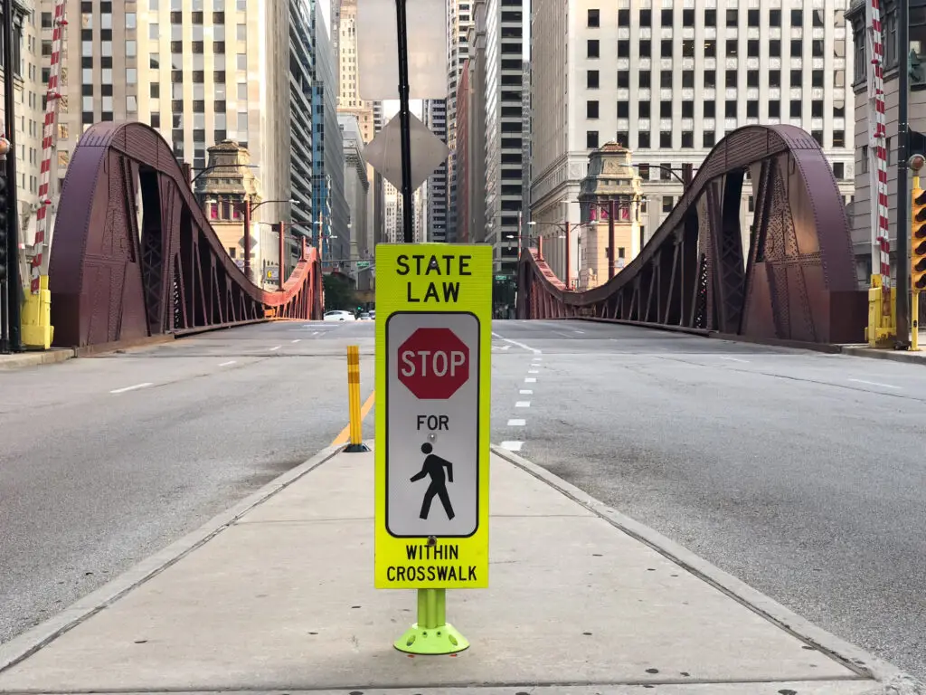 This sign indicates to stop for pedestrians up ahead.