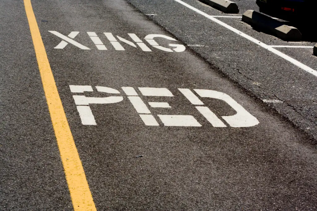 This sign indicates an upcoming pedestrian crossing.