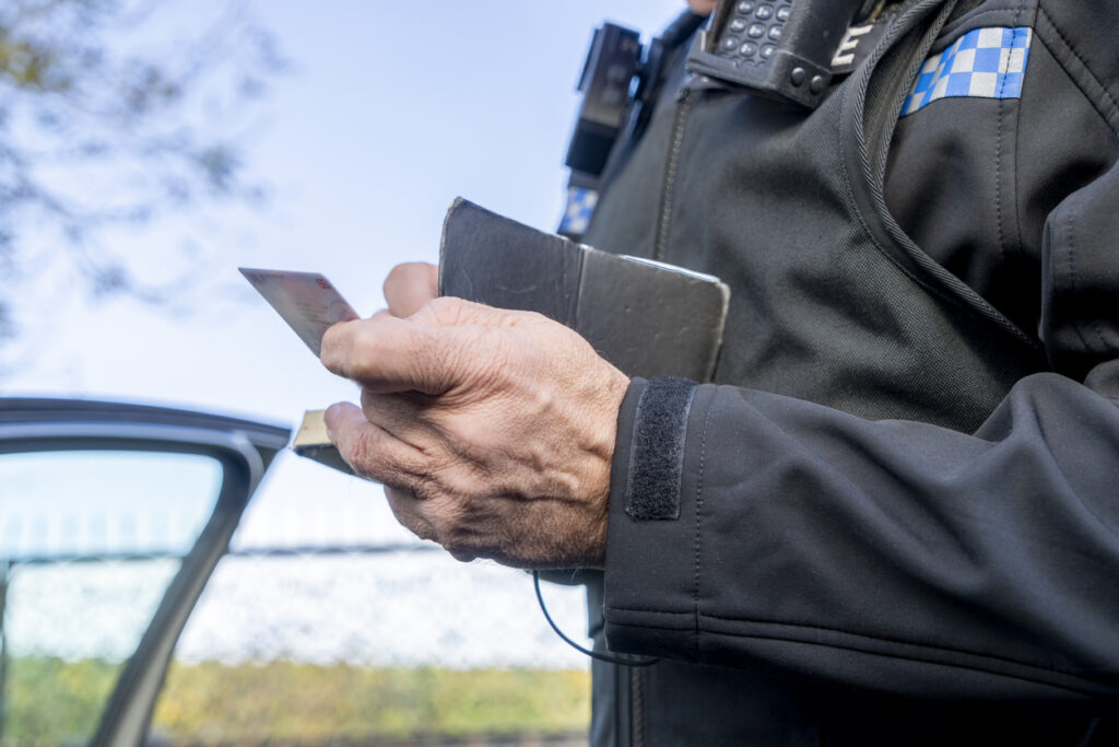 A police officer giving a ticket.