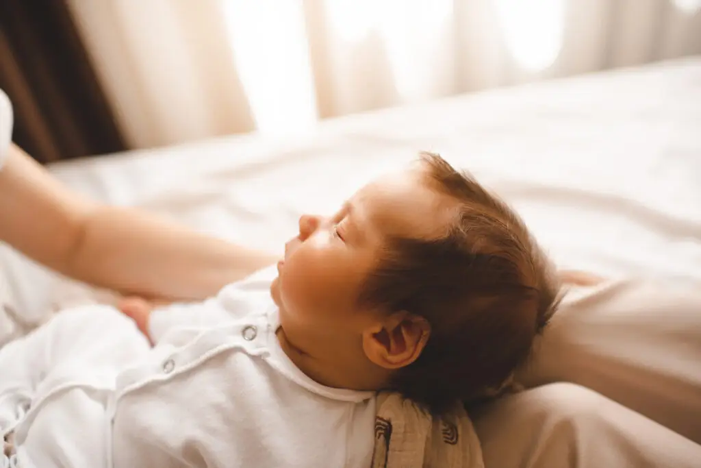 A sick baby being taken care of by his mother.