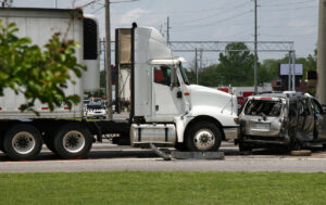 A two vehicle crash took the life of a woman and injured a man involving a semi-truck and a motor vehicle on Wednesday evening.